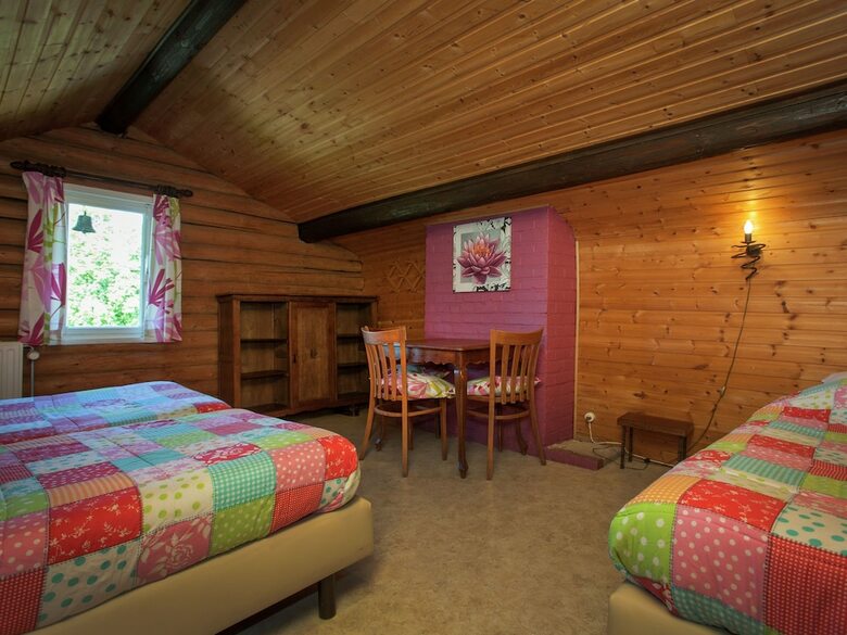 Open Wooden Chalet Built Against A Hill