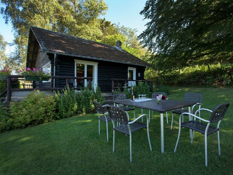 Open Wooden Chalet Built Against A Hill